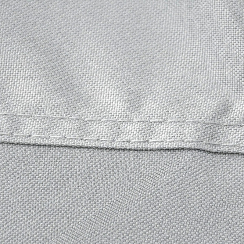Close-up of a fabric surface with a horizontal seam dividing it into a light gray upper section and a black lower section.