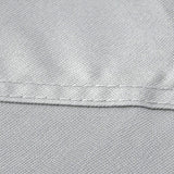 Close-up of a fabric surface with a horizontal seam dividing it into a light gray upper section and a black lower section.